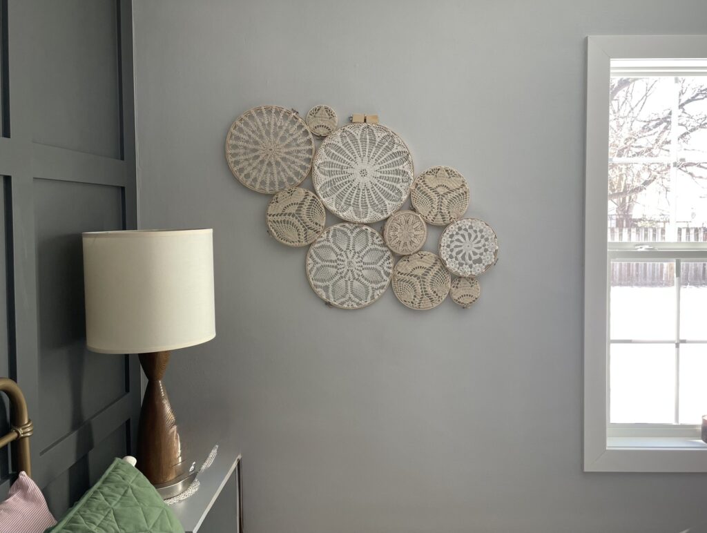 Finished doily wall decor project hanging decoratively on the wall.